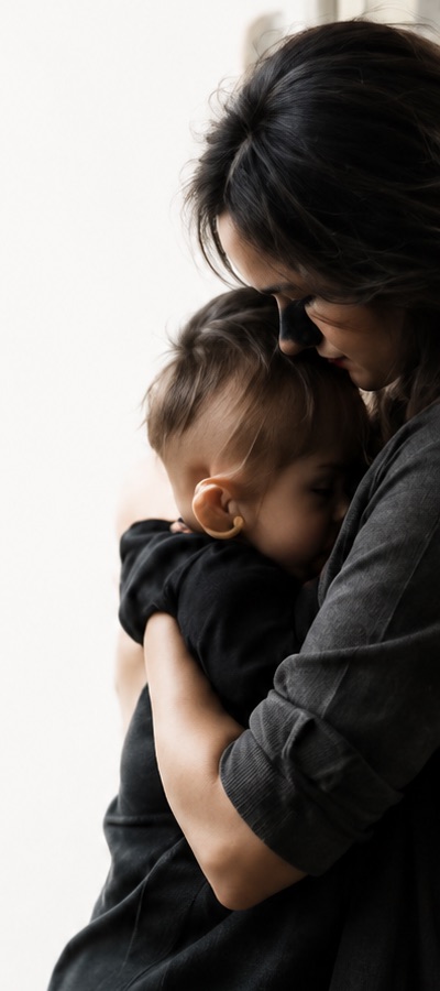 Mother holding her child in a quiet supportive moment